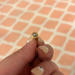 Coach rose gold stud earrings with light blue center.